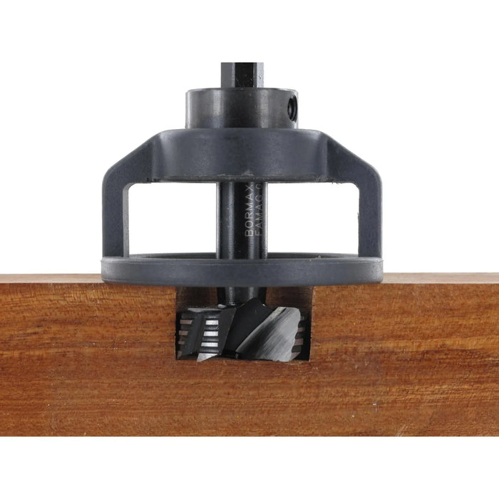 Woodworking router bit inserted into a wooden board on a white background