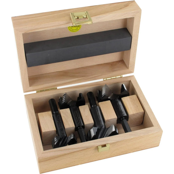 Set of 4 black forstner bits in a wooden box on a white background