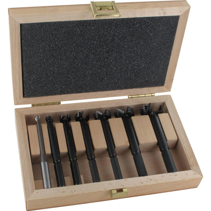 Set of 7 black forstner bits in a wooden box on a white background