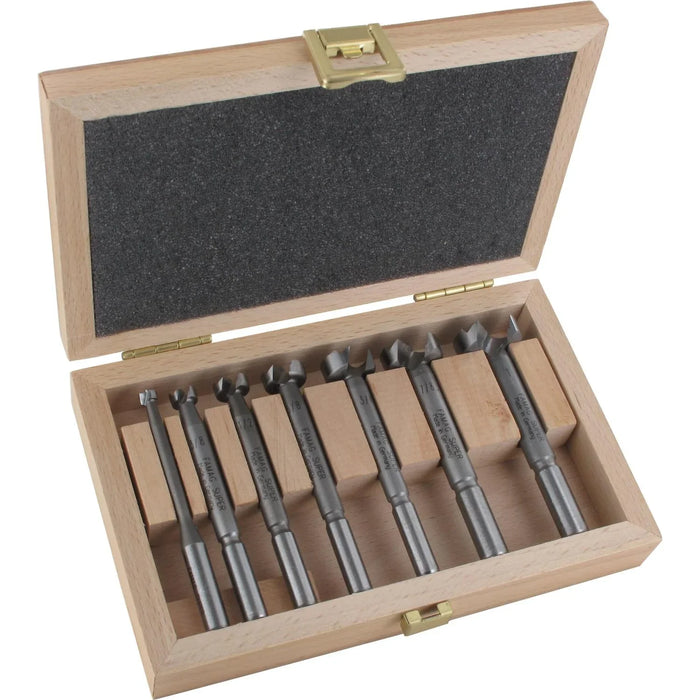 Set of drill bits in a wooden case on a white background