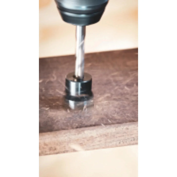 Drill bit being used on a wooden surface