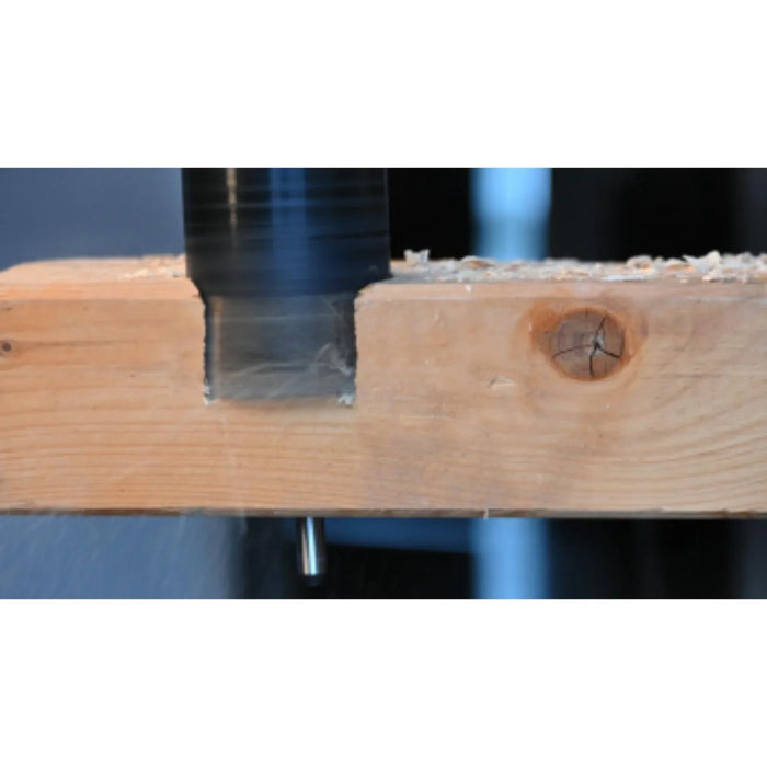 hole saw drilling into a wood beam