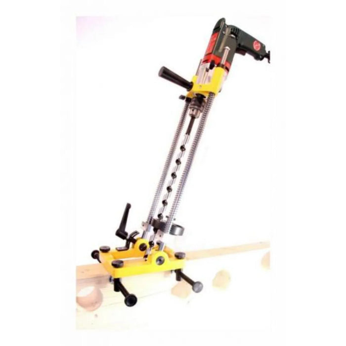 Yellow swivelling drill stand clamped to a wood beam in a reclined position with a drill in place on a white background