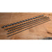 Set of drill bits of varying diameters on a wooden surface