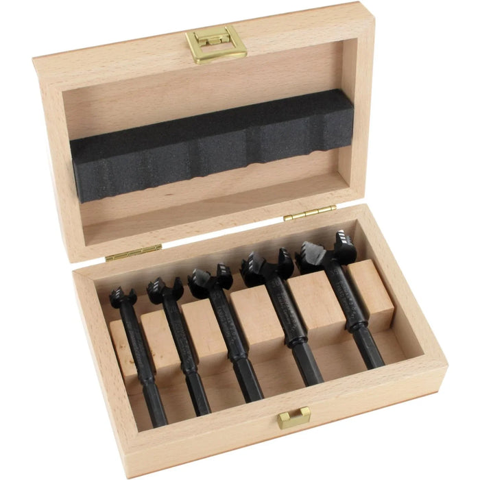 Set of 5 black forstner bits in a wooden box on a white background