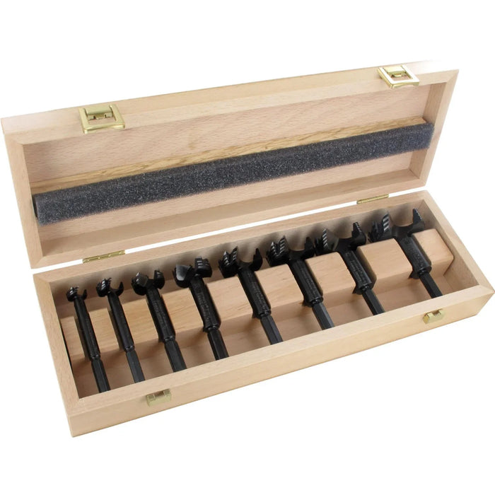 Set of 8 black forstner bits in a wooden box on a white background