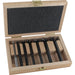 Set of 7 black forstner bits in a wooden box on a white background
