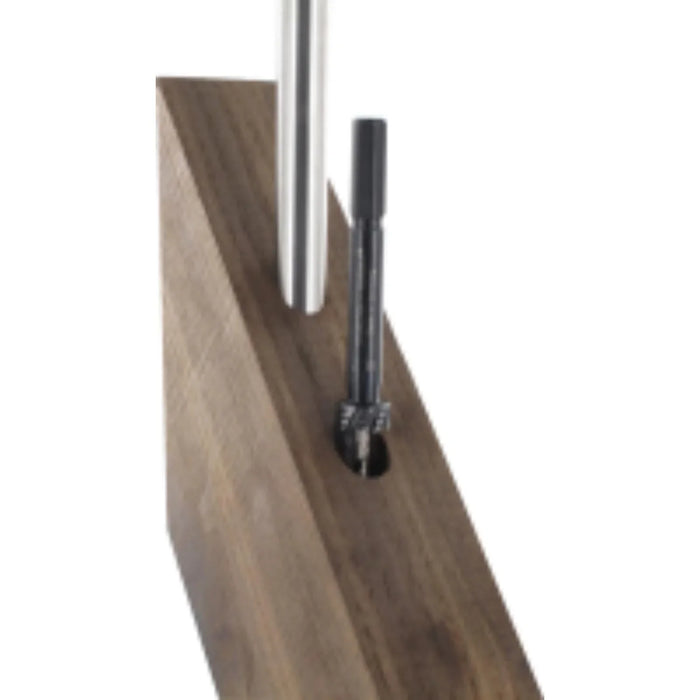 Wooden surface rod inserted into hole with second hole being drilled