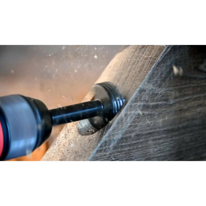 Drill bit being used on a piece of wood with visible sparks.