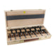 Set of 15 black forstner bits in a wooden box on a white background