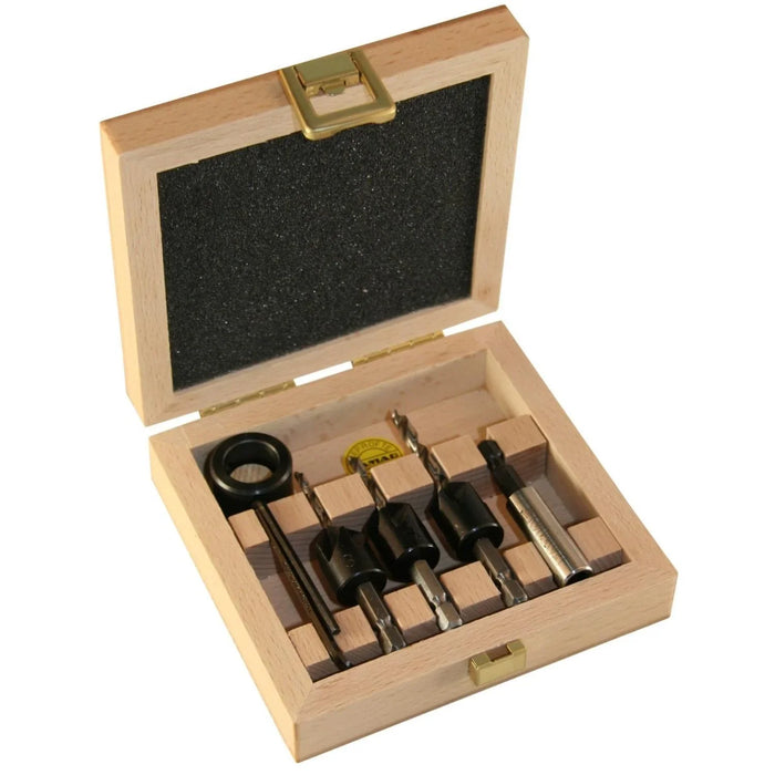 Set of drill bits and countersinks in a wooden box on a white background