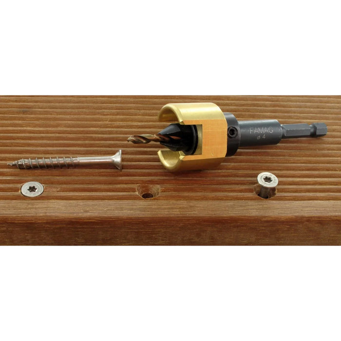 Gold colored depth stop on a drill bit on a wooden surface with screws