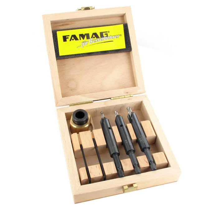 Set of drill bits in a wooden box with FAMAG branding on a white background