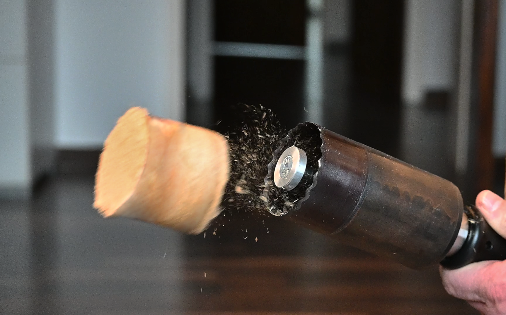 wood core being ejected from a hole saw